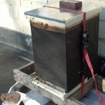 The rooftop hive is wrapped with tar paper, strapped down and ready for winter.