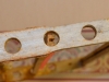 The holes on the end bars that Dean made.
