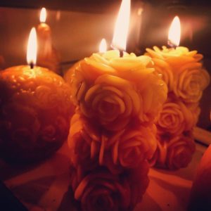 Rose Pillar and Fleur De Lys Ball Beeswax Candles Burning